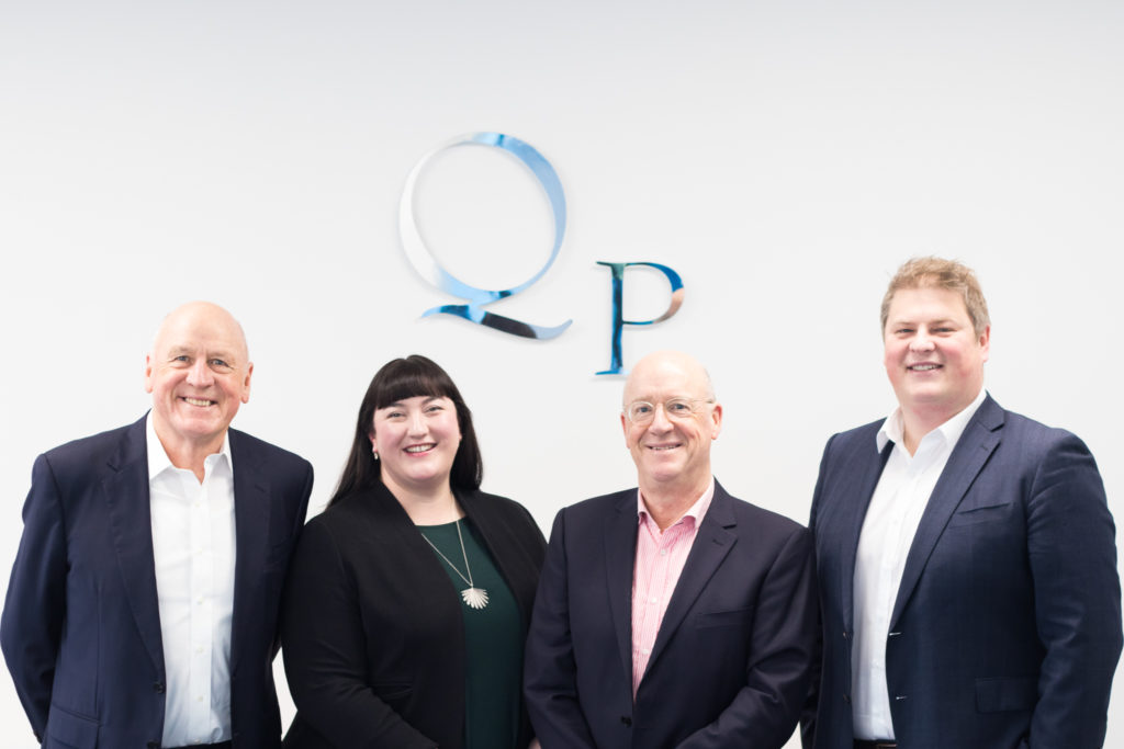 photo of the four partners at Quigg Partners
